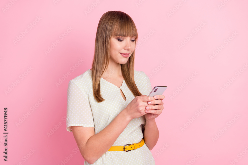 Portrait of attractive focused addicted girl using gadget app 5g browsing multimedia isolated over pink pastel color background Portrait of attractive focused addicted girl using gadget app 5g browsing multimedia isolated over pink pastel color background
