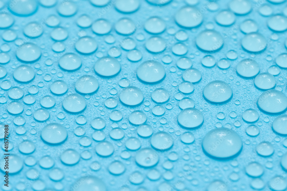 Water drops on blue background texture. Backdrop glass covered with drops of water. bubbles in water