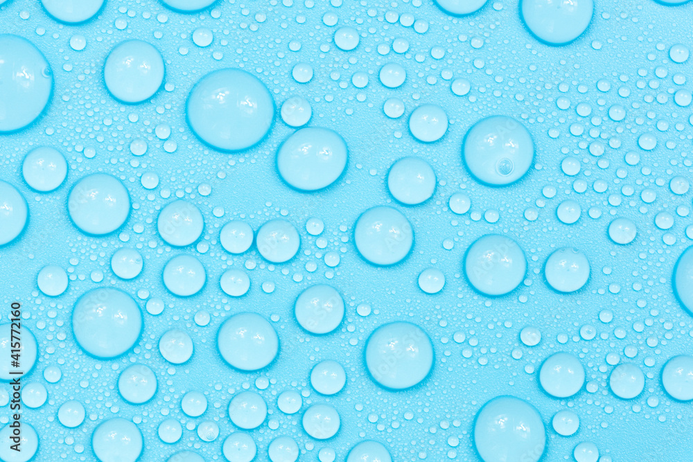 Water drops on blue background texture. Backdrop glass covered with drops of water. bubbles in water