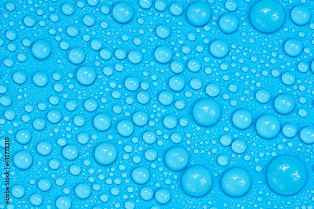 Water drops on blue background texture. Backdrop glass covered with drops of water. bubbles in water