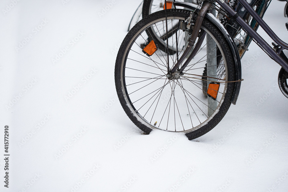 Bike standing at the snow at the street Bike standing at the snow at the street