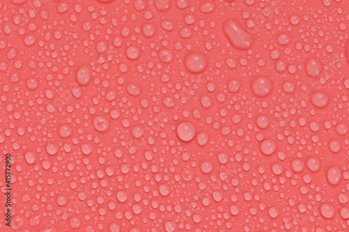 Water drops on red background texture. backdrop glass covered with drops of water.  bubbles in water
