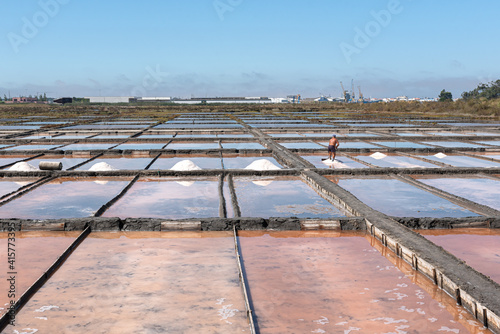 Different types of salt in salt pans with salt harvesting pools photo