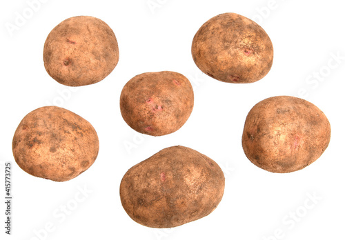 Unwashed fresh potatoes with pink eyes on a white background isolated.