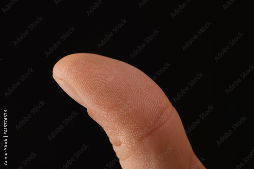 Man scanning fingerprint on black background, closeup
