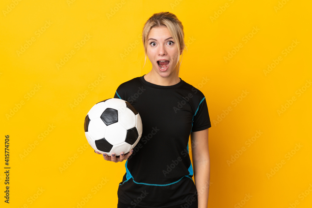Young Russian football player woman isolated on yellow background with surprise facial expression Young Russian football player woman isolated on yellow background with surprise facial expression