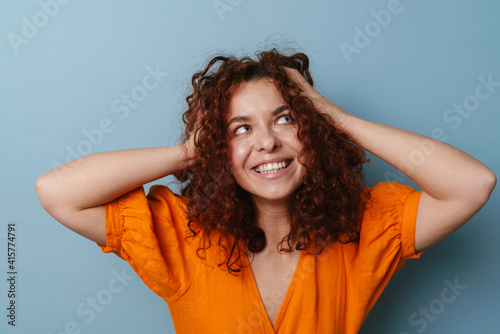 Happy ginger woman smiling and grabbing her head