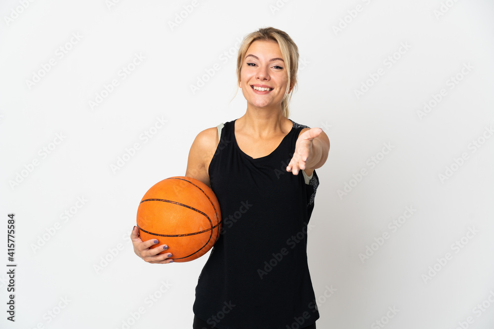 Young Russian woman playing basketball isolated on white background shaking hands for closing a good deal Young Russian woman playing basketball isolated on white background shaking hands for closing a good deal