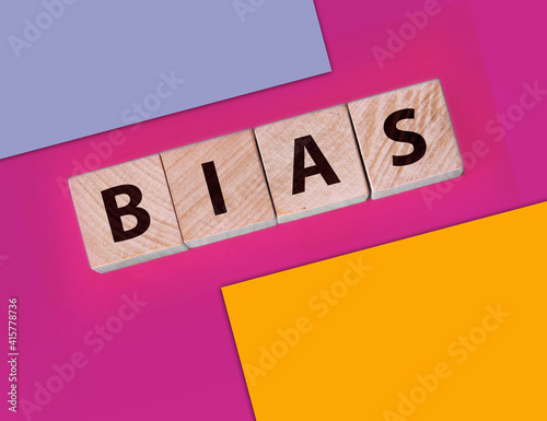 the word bias on wooden blocks blue background photo
