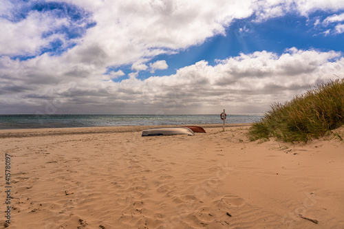 Fishing boat on the beach in front of the sea