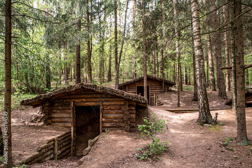 Wooden dugouts hidden in the forest