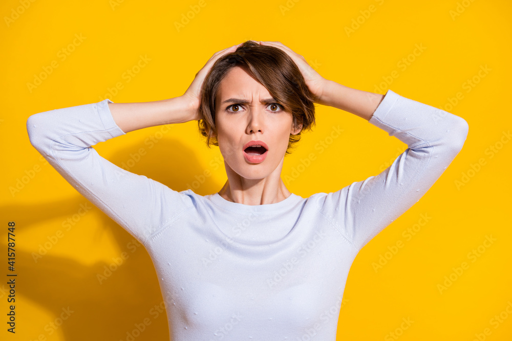 Fototapeta premium Photo portrait of unhappy woman in panic touching head isolated on bright yellow colored background