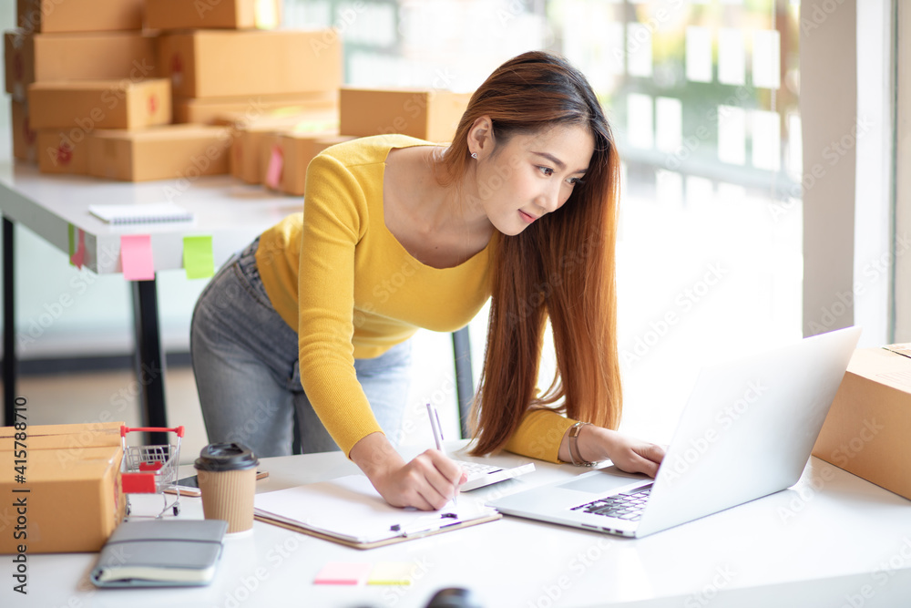 Small business entrepreneur SME freelance,Portrait of young asian woman working at home office,online marketing packaging delivery box,e-commerce business concept. Small business entrepreneur SME freelance,Portrait of young asian woman working at home office,online marketing packaging delivery box,e-commerce business concept.