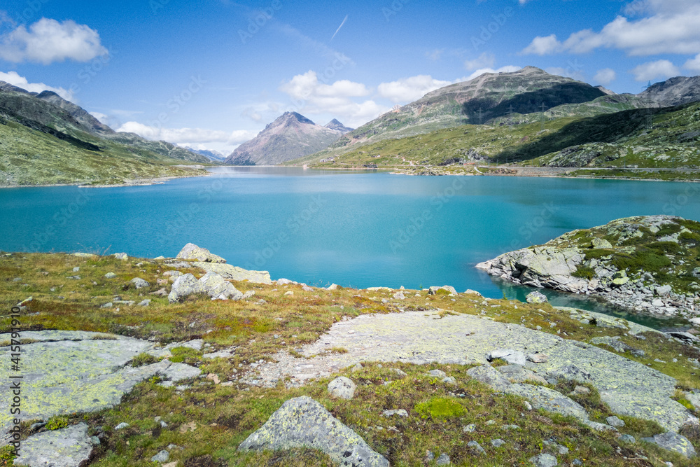 Summer mountain scenery in Swiss Alps. Majestic mountains above turquoise lake. Sunny day in nature.