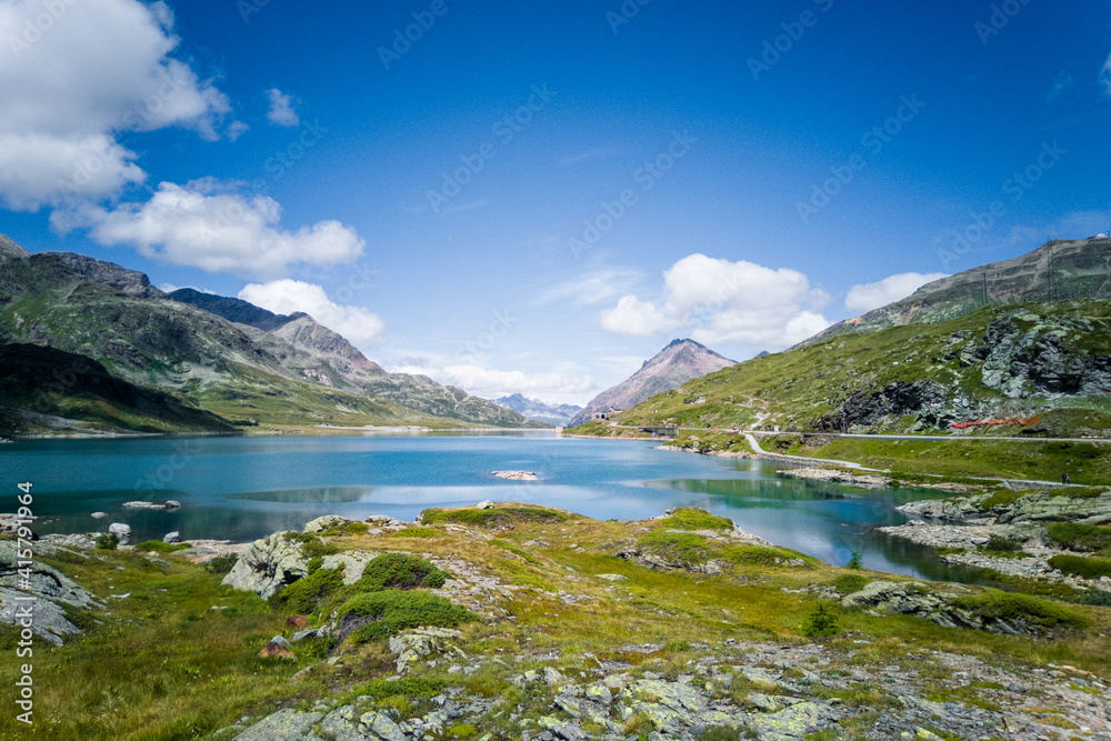 Amazing panoramic view of summer mountain landscape. Mountain lake in Swiss Alps. Sunny day in nature.