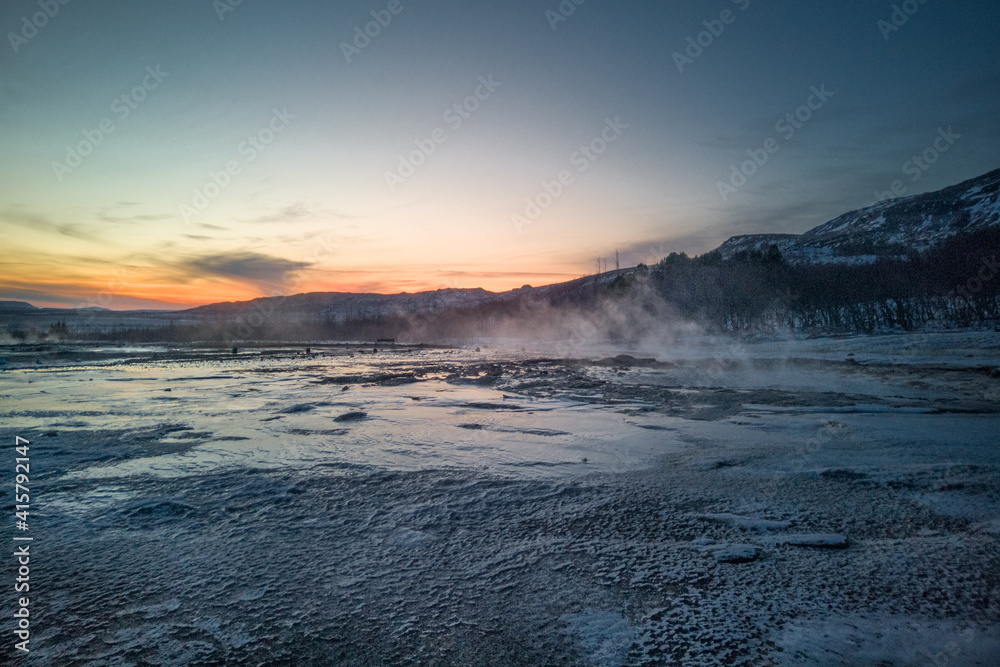 Fototapeta premium Scenic view on Nordic winter landscape. Geyser against sky during sunset. Preserved nature in Iceland. Geothermal energy concept.
