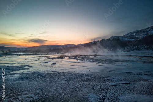 Scenic view on Nordic winter landscape. Geyser against sky during sunset. Preserved nature in Iceland. Geothermal energy concept.