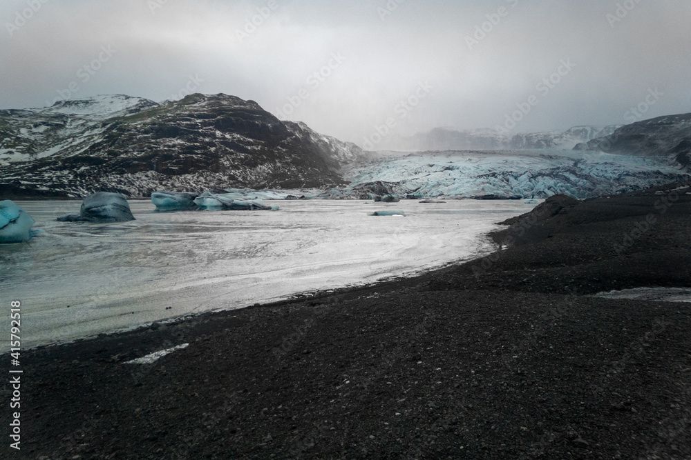 Impressive view of lake with ice floes of melting glacier. Foggy day in Icelandic nature. Cold and icy concept.