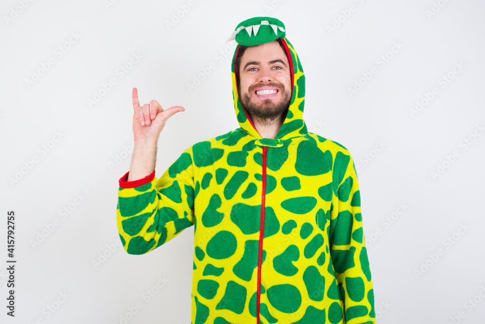 Fototapeta premium young caucasian man wearing a pajama standing against white background showing up number six Liu with fingers gesture in sign Chinese language