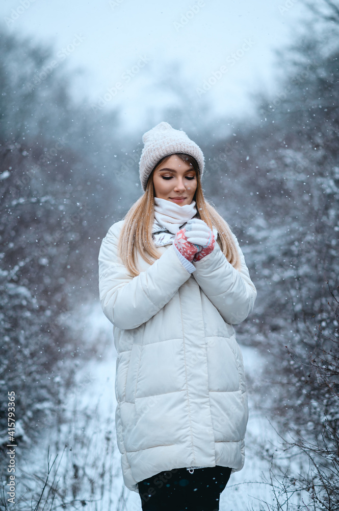 Beautiful girl walking in the winter forest Beautiful girl walking in the winter forest