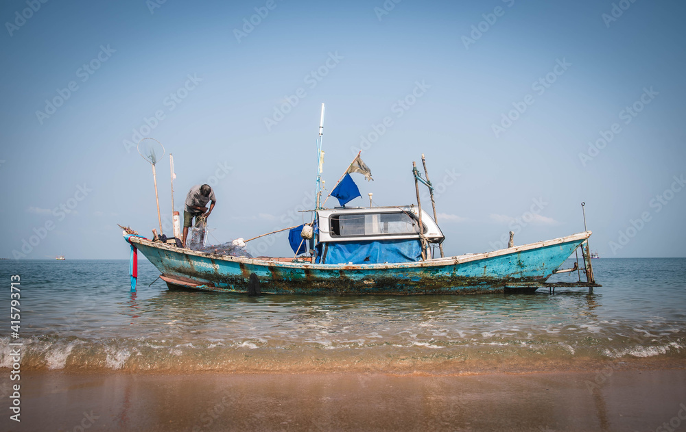 A traditional fishing boat parked on the beach of Ban Bang Saray, Chon Buri Province, Thailand