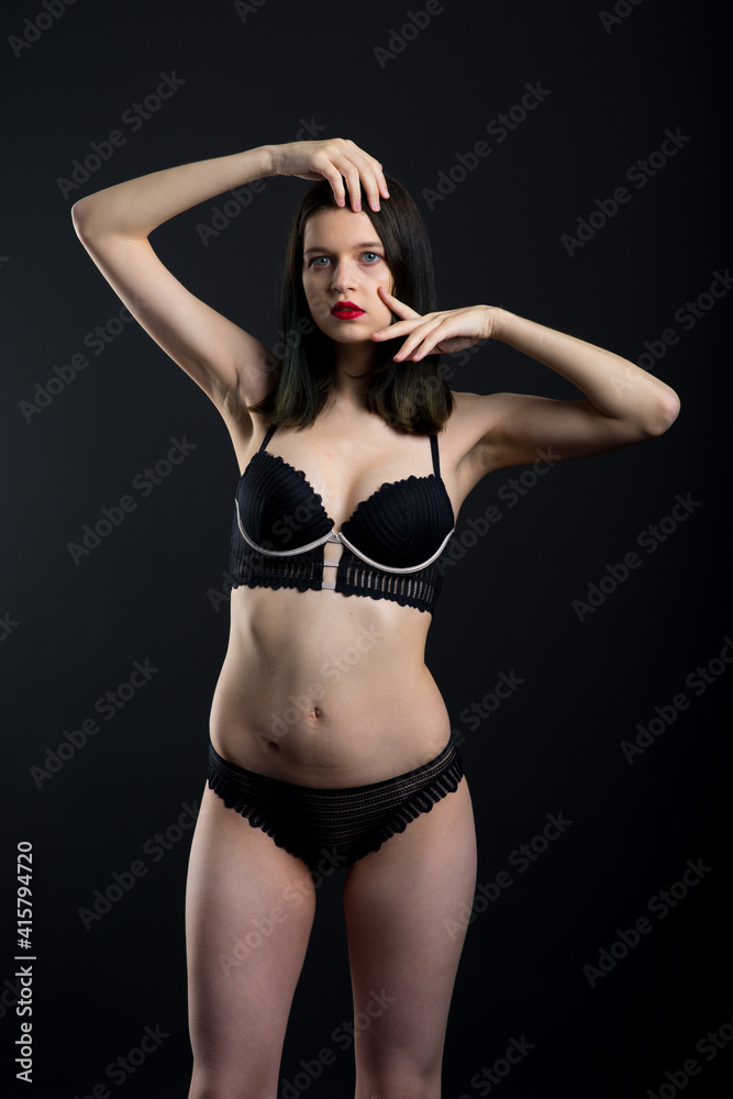 Appealing female model with seductive figure and brunette haircut in the black lingerie