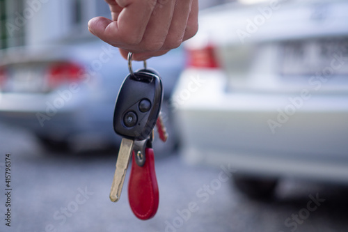 Employees sale send car keys to tourists after making a lease. Rent or buy car concept