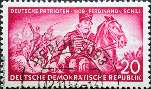 GERMANY, DDR - CIRCA 1953 : a postage stamp from Germany, GDR showing a portrait of Ferdinand von Schill, Prussian officer and freedom fighter; attacking hussars. Text: German patriots photo