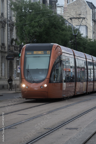 Orange tram running in the city