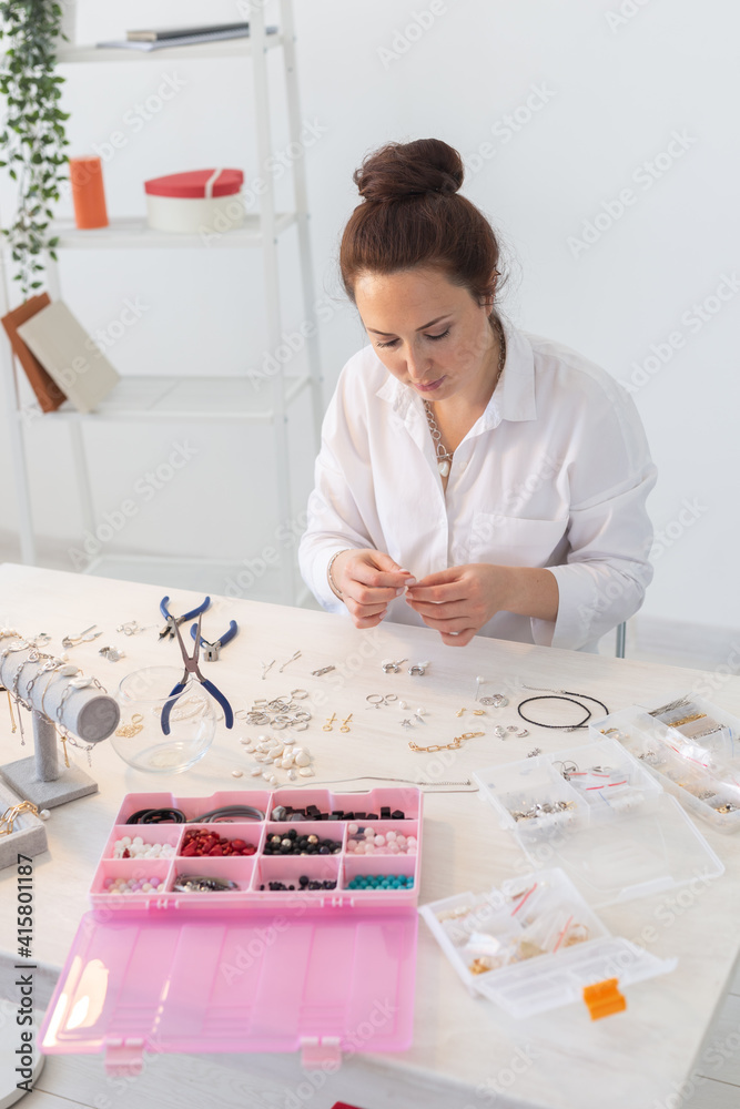 Professional accessories designer making handmade jewelry in studio workshop. Fashion, creativity and handmade concept.