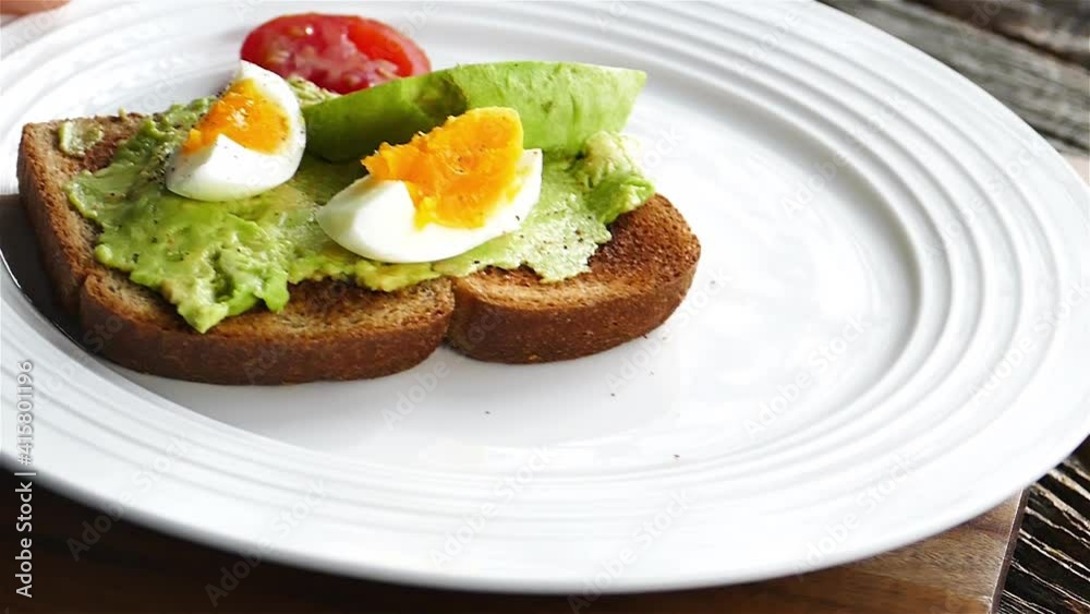 Avocado toast on white plate is added to table Avocado toast on white plate is added to table