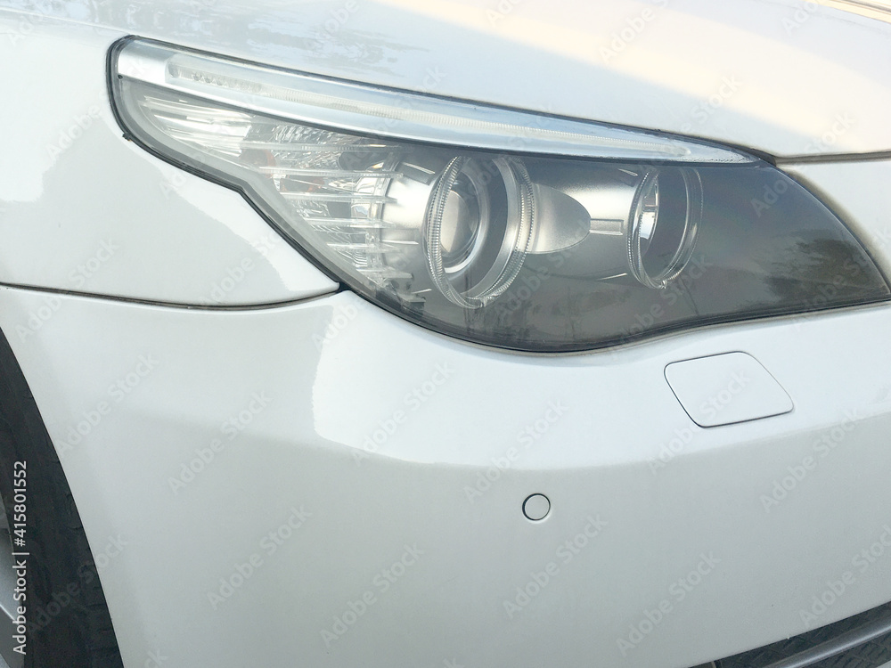 Modern car headlight.Exterior closeup detail.

