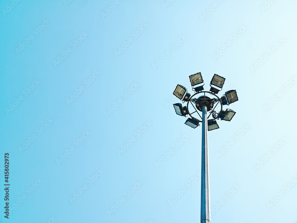 Low Angle View of Circular Lamps at Top of the Post Against Clear Blue Sky Low Angle View of Circular Lamps at Top of the Post Against Clear Blue Sky
