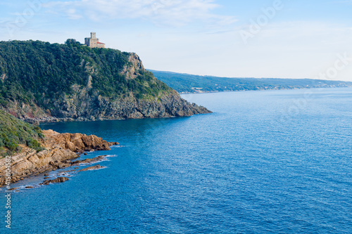 Livorno, Tuscany, Italy: Beach and cliffs of calafuria. The tower indicates the cliff under the Aurelia bridge: a beautiful sea, a classic diving destination. photo