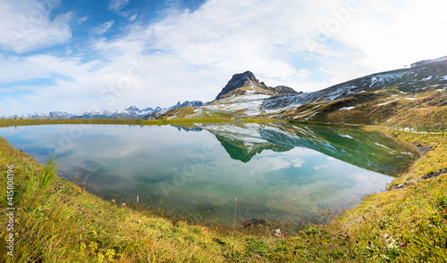 beautiful alpine lake Riezler Alpsee, with reflection of Walser Hammerspitze mountain, allgau alps photo