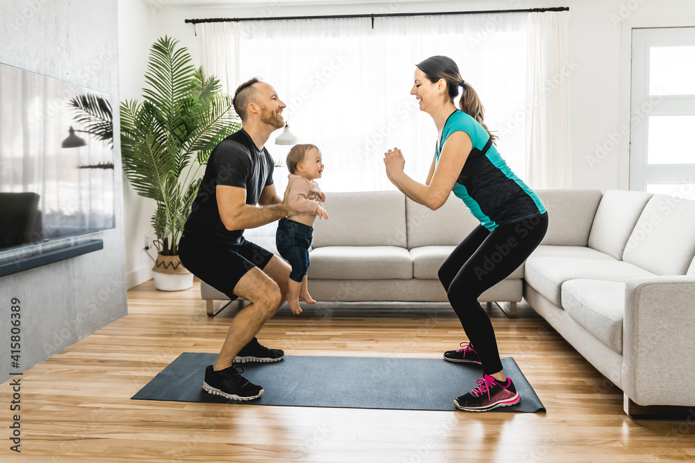 Happy couple training with his baby the baby looks at someone. Happy couple training with his baby the baby looks at someone.