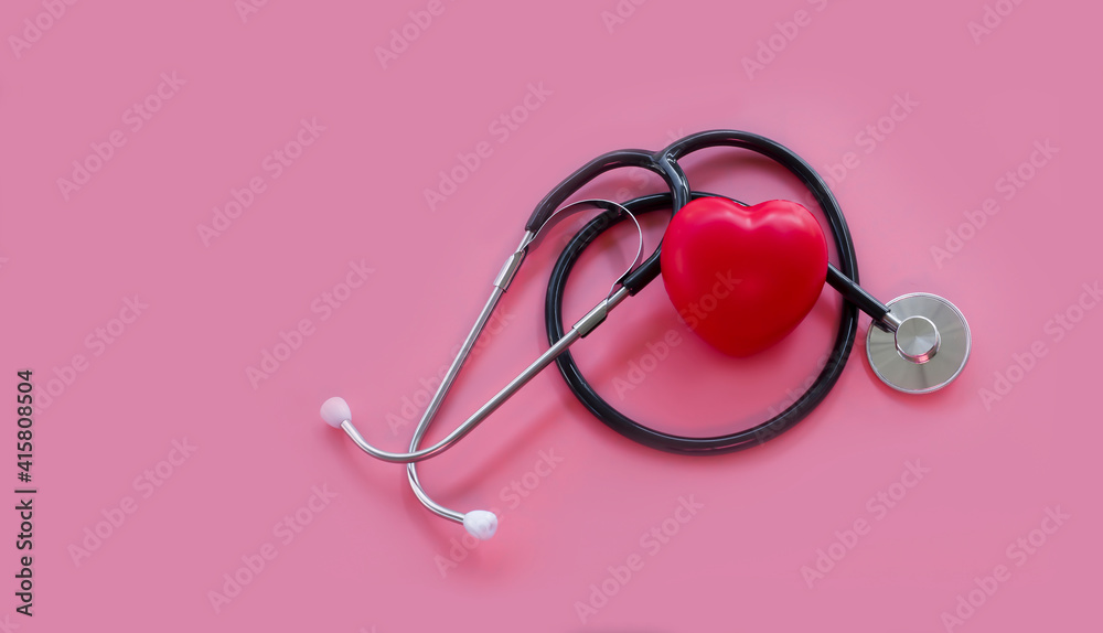Stethoscope and red hearts on a pink background, Health care concept.