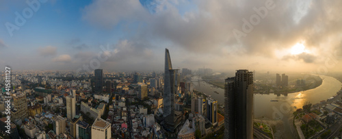 Ho Chi Minh City, District One, Vietnam. Classic drone panorama of all key buildings and the Saigon River in golden morning sunlight.