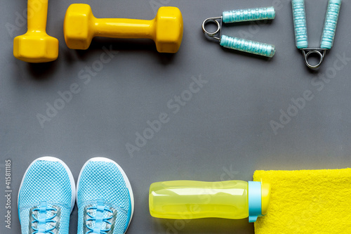 Frame of fitness gym equipment with dumbbells and sneakers