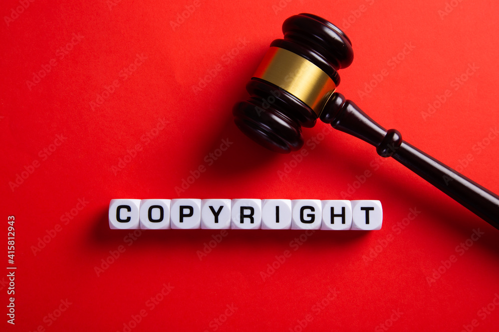 Copyright word and a judge gavel. Concept of legal education.