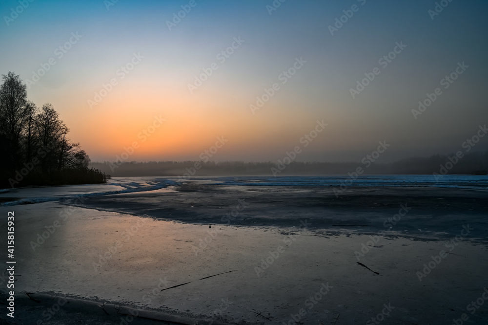 sunrise over frozen lake outside Kumla Sweden