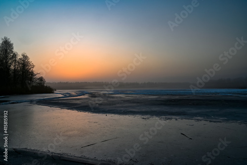 sunrise over frozen lake outside Kumla Sweden