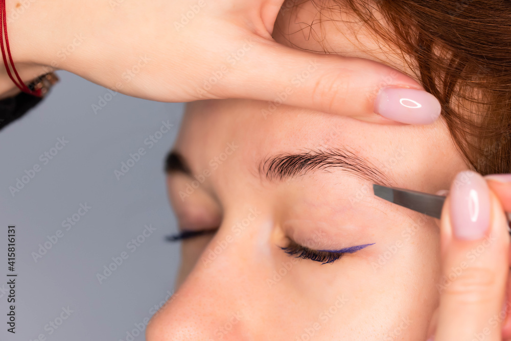 Young Caucasian Woman on the brow beauty procedures. Professional care for face. Brows coloring, wax and lamination. 