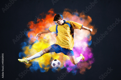 Soccer player kicking ball in colorful smoke