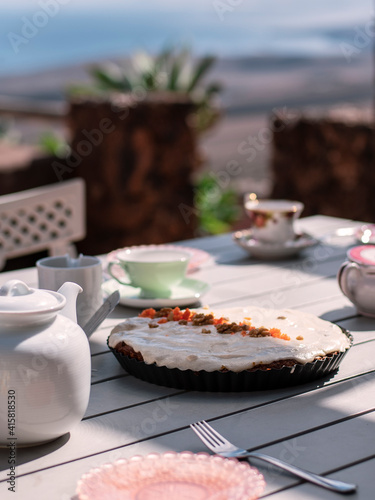 served table with tea pot and vegan bakery for teatime outdoors