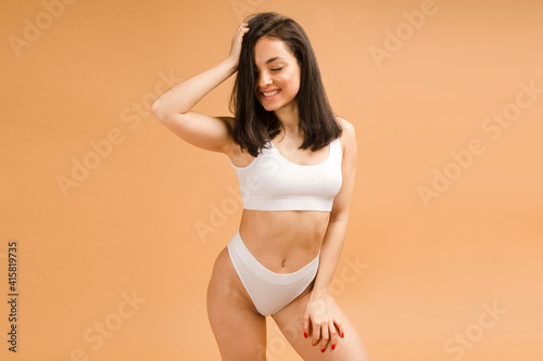 Sexy and beautiful woman in underwear. Beautiful and healthy girl with young and fit body posing in underwear. Sport, fitness, diet, nutrition and health care concept.