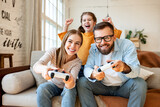 Girl supporting parents playing videogame
