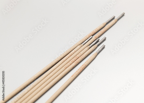 scattered welding electrodes, a pile, on a light background