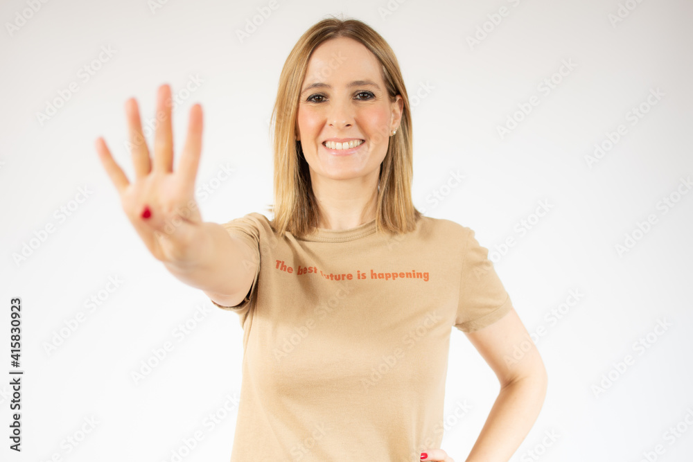 Young woman over isolated white background happy and counting four with fingers Young woman over isolated white background happy and counting four with fingers