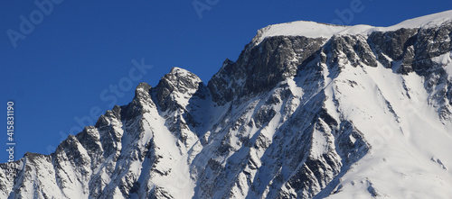 Snow covered rugged mountain seen from Elm, Switzerland. photo